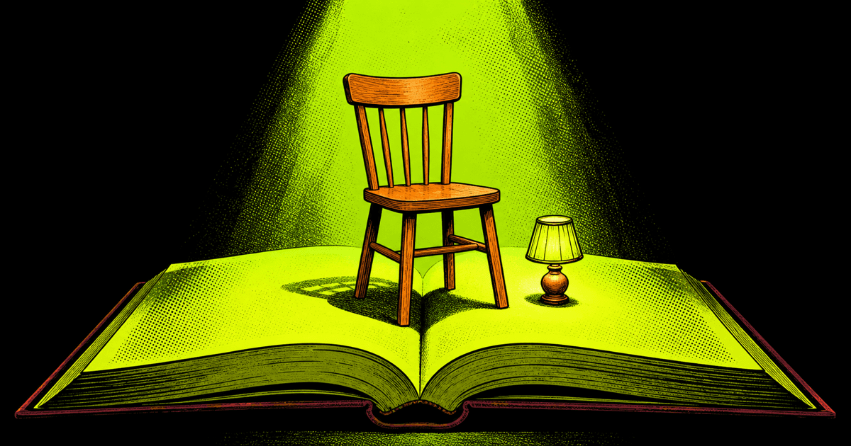 Plain wooden chair and table lamp spotlit on a giant open book